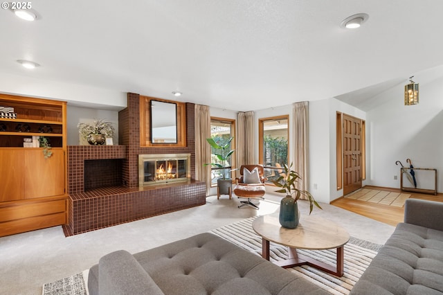 carpeted living area featuring a fireplace