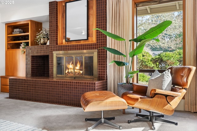 living area featuring carpet flooring and a fireplace