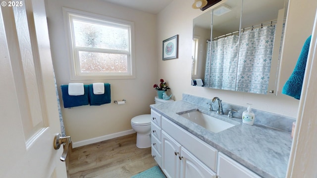 full bathroom featuring vanity, toilet, baseboards, curtained shower, and wood finished floors