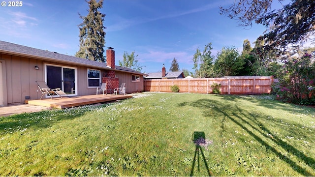 view of yard featuring fence and a deck