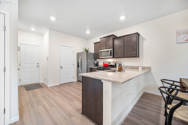 3563 SE Richey Rd, Gresham, OR 97080 - kitchen featuring stainless steel appliances, light wood finished floors, dark brown cabinetry, baseboards, and recessed lighting
