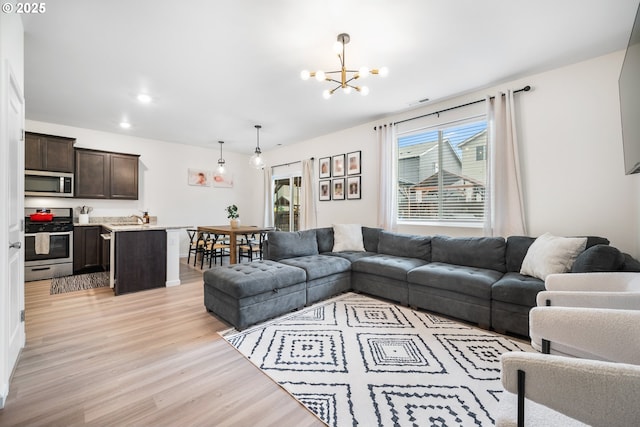 3563 SE Richey Rd, Gresham, OR 97080 - living room with light wood-style floors and a chandelier