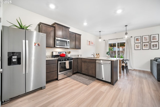 3563 SE Richey Rd, Gresham, OR 97080 - kitchen with appliances with stainless steel finishes, dark brown cabinets, light wood-type flooring, a sink, and recessed lighting
