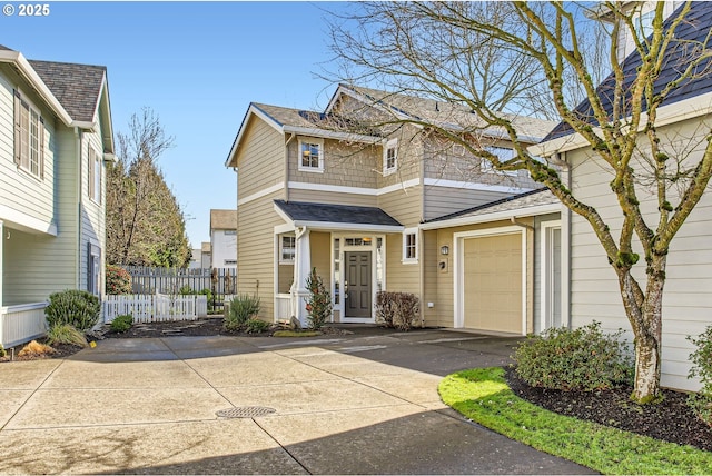 view of front facade featuring driveway, an attached garage, fence, and roof with shingles