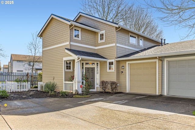 view of front facade featuring driveway, an attached garage, and fence