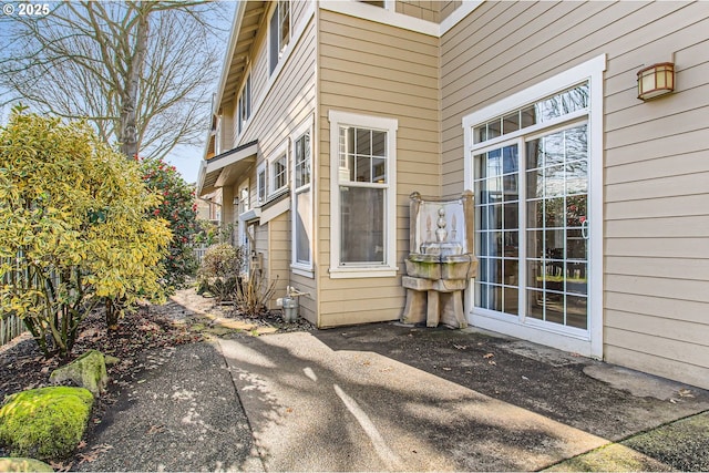 view of exterior entry with a patio area