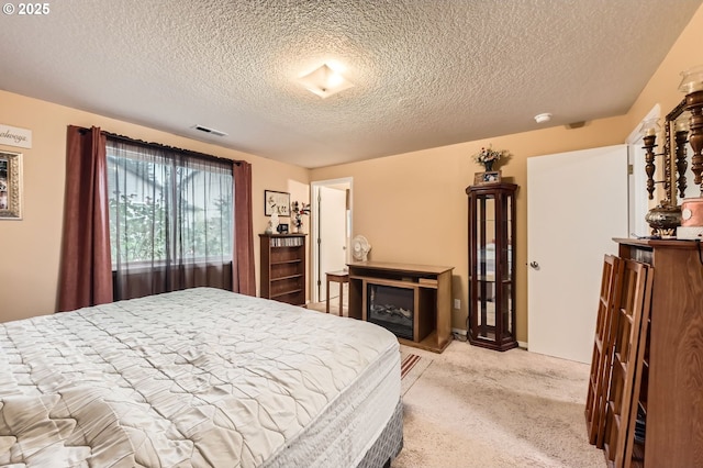 15619 NE Hickory St, Vancouver, WA 98682 - bedroom with light colored carpet, a textured ceiling, and a fireplace