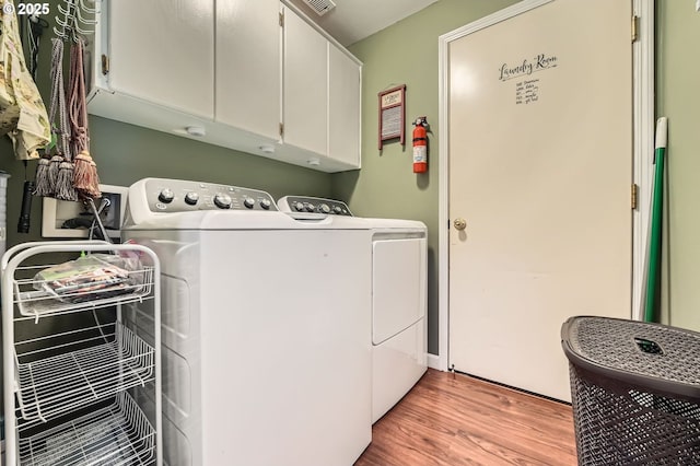 15619 NE Hickory St, Vancouver, WA 98682 - laundry room featuring cabinet space, independent washer and dryer, and light wood finished floors