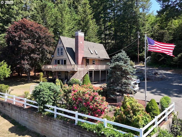 17769 Rainbow Rock Rd, Brookings, OR 97415 - back of property featuring a wooden deck, stairs, a chimney, and roof with shingles