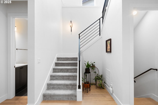 15625 NW Gooderham St, Portland, OR 97229 - stairway featuring wood finished floors and baseboards