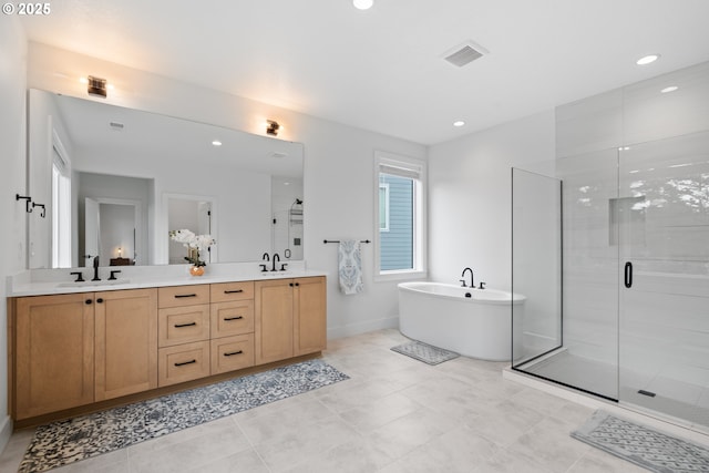 15625 NW Gooderham St, Portland, OR 97229 - bathroom with double vanity, a stall shower, a freestanding tub, and recessed lighting