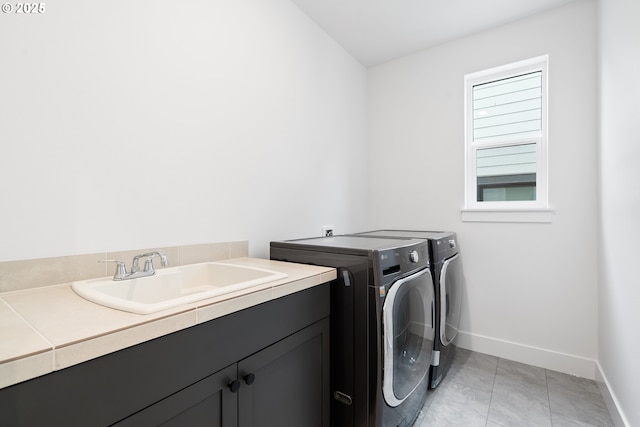 15625 NW Gooderham St, Portland, OR 97229 - laundry area with cabinet space, washer and dryer, and light tile patterned floors
