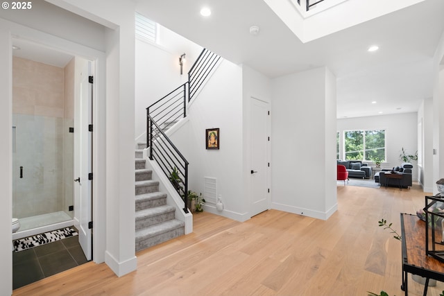 15625 NW Gooderham St, Portland, OR 97229 - stairway with wood finished floors, recessed lighting, and a skylight