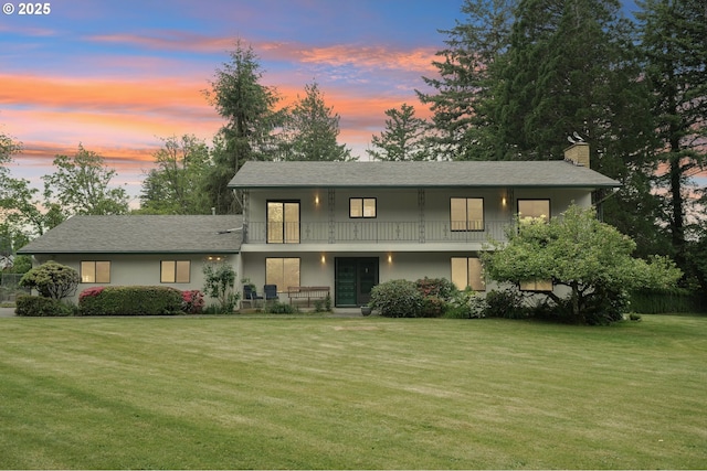 28040 SE Stark St, Troutdale, OR 97060 - view of front of home with a chimney, a front yard, a balcony, a porch, and stucco siding