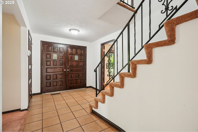 28040 SE Stark St, Troutdale, OR 97060 - entryway with stairway, baseboards, tile patterned flooring, and a textured ceiling