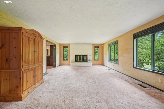 28040 SE Stark St, Troutdale, OR 97060 - unfurnished living room with a textured ceiling, plenty of natural light, carpet floors, and a fireplace