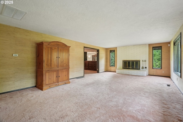 28040 SE Stark St, Troutdale, OR 97060 - unfurnished living room with a textured ceiling, plenty of natural light, light colored carpet, and a fireplace
