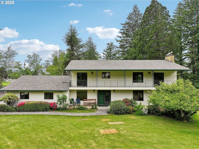 28040 SE Stark St, Troutdale, OR 97060 - view of front of property with a balcony, a chimney, a front lawn, stucco siding, and roof with shingles