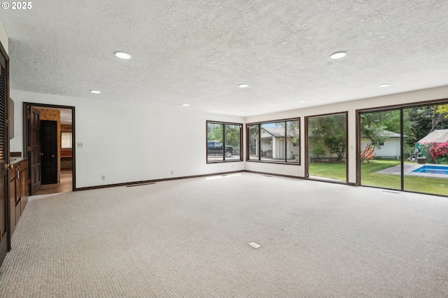 28040 SE Stark St, Troutdale, OR 97060 - carpeted empty room featuring a textured ceiling, plenty of natural light, recessed lighting, and baseboards