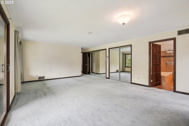 28040 SE Stark St, Troutdale, OR 97060 - unfurnished bedroom with multiple closets, carpet floors, baseboards, and connected bathroom