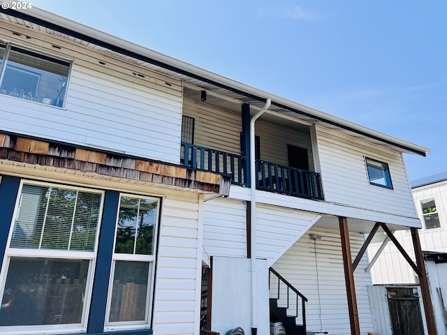 back of house featuring stairs