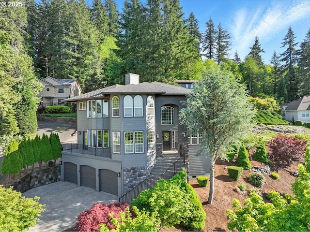 13658 SE Snowfire Dr, Happy Valley, OR 97086 - view of front facade with a garage, a chimney, and driveway