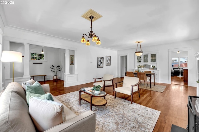 4823 NE 21st Ave, Portland, OR 97211 - living room with decorative columns, wood finished floors, and a chandelier