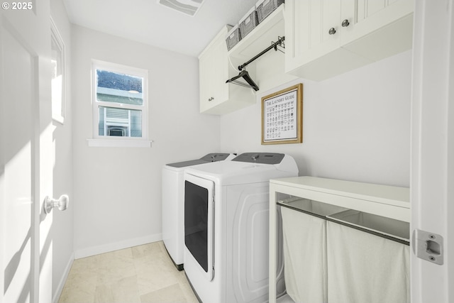 laundry room featuring cabinets and washing machine and clothes dryer