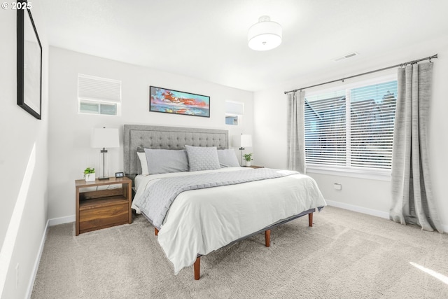 bedroom featuring light carpet