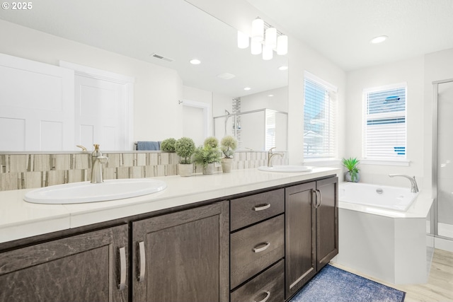 bathroom with plus walk in shower and vanity