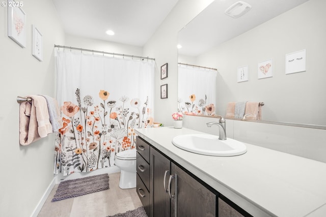 bathroom featuring vanity and toilet