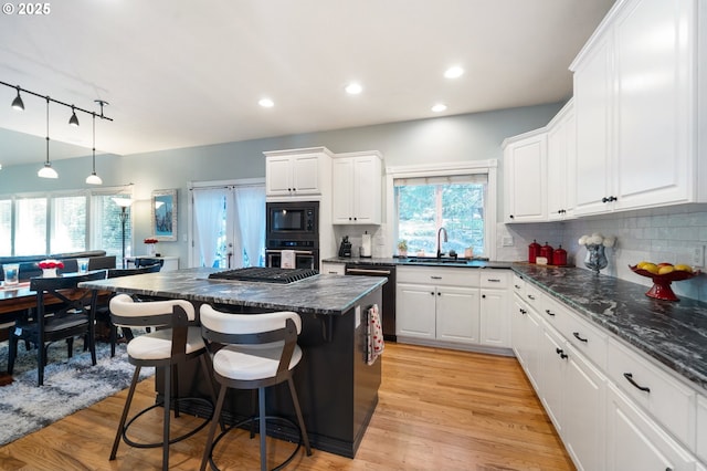 16420 SW Sienna Ln, Beaverton, OR 97007 - kitchen with built in microwave, oven, dishwasher, a kitchen island, and white cabinets