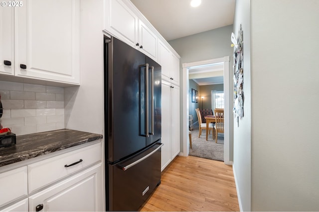 16420 SW Sienna Ln, Beaverton, OR 97007 - kitchen with high quality fridge, white cabinets, tasteful backsplash, and light wood-style flooring