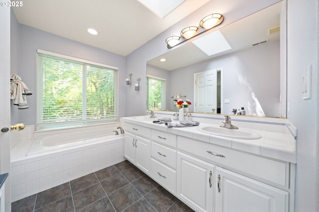 16420 SW Sienna Ln, Beaverton, OR 97007 - bathroom featuring a skylight, double vanity, a garden tub, and tile patterned flooring