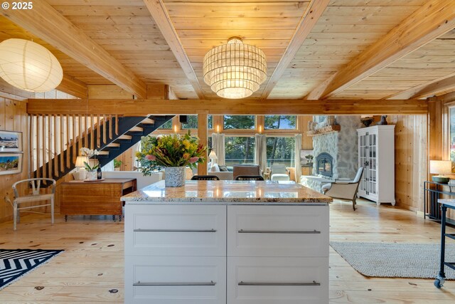 53461 Safe Rd, Bandon, OR 97411 - kitchen with light wood finished floors, wooden ceiling, light stone countertops, beam ceiling, and white cabinetry