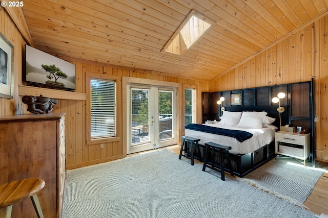 53461 Safe Rd, Bandon, OR 97411 - bedroom with wooden walls, lofted ceiling with skylight, wood ceiling, and access to outside