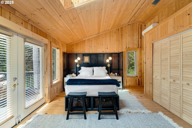 53461 Safe Rd, Bandon, OR 97411 - bedroom featuring lofted ceiling, wooden walls, light wood-style floors, and access to exterior