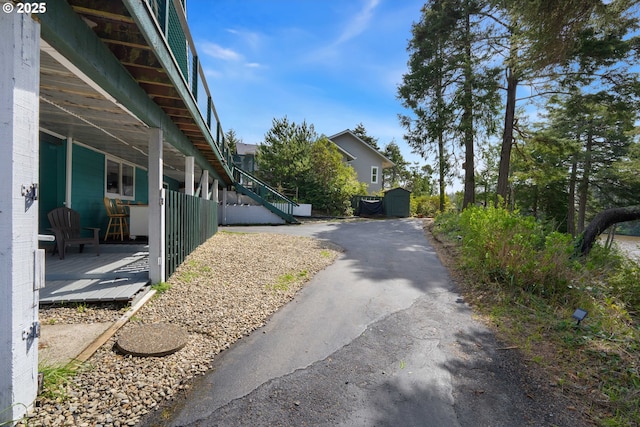 53461 Safe Rd, Bandon, OR 97411 - view of side of home featuring a storage unit and an outbuilding