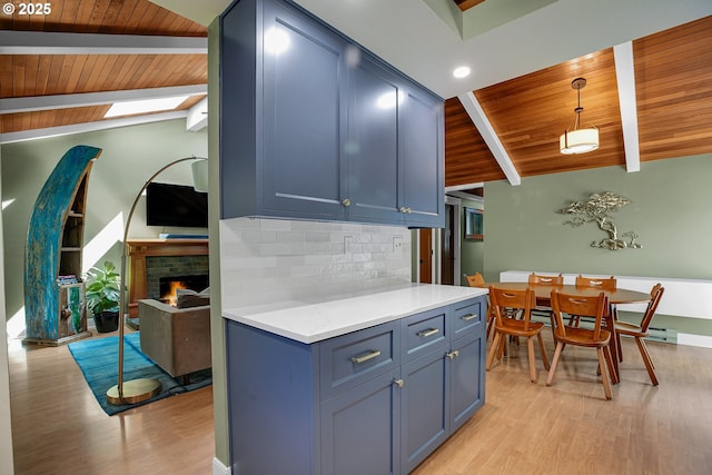 21482 SW 92nd Ct, Tualatin, OR 97062 - kitchen with wooden ceiling, light wood-style flooring, tasteful backsplash, light countertops, and pendant lighting