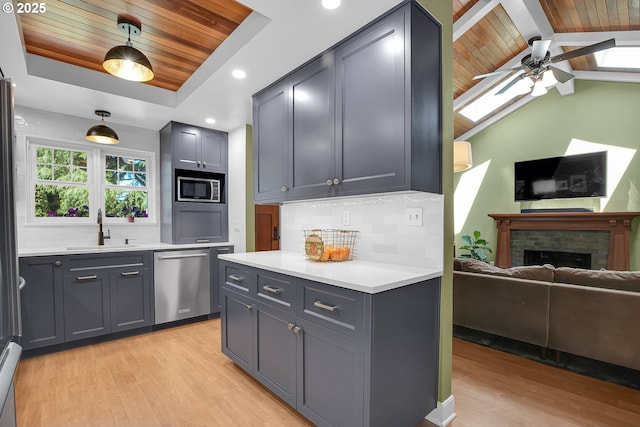 21482 SW 92nd Ct, Tualatin, OR 97062 - kitchen with wood ceiling, appliances with stainless steel finishes, light wood-type flooring, backsplash, and ceiling fan