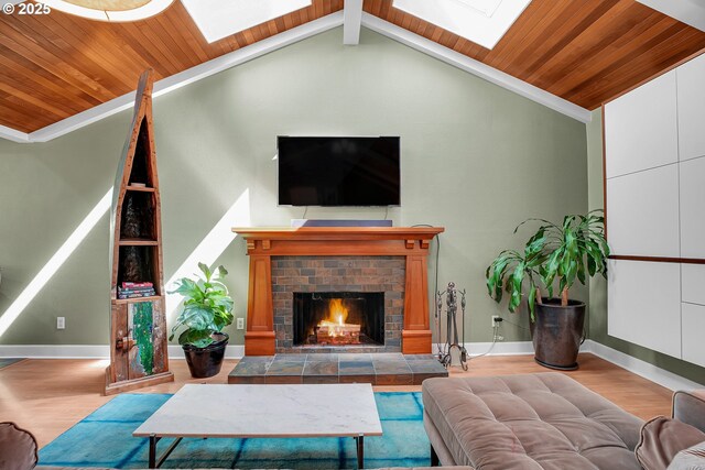 21482 SW 92nd Ct, Tualatin, OR 97062 - living area featuring a skylight, wood finished floors, wood ceiling, a fireplace, and baseboards