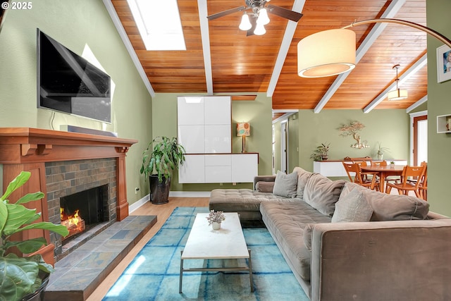 21482 SW 92nd Ct, Tualatin, OR 97062 - living room featuring wood ceiling, ceiling fan, wood finished floors, and a tile fireplace