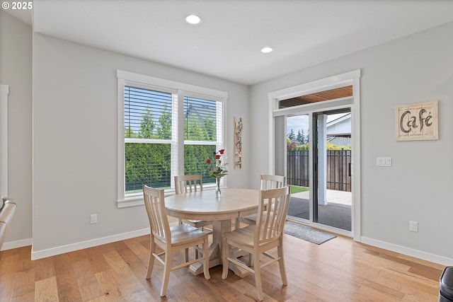 dining area with baseboards, recessed lighting, and light wood finished floors