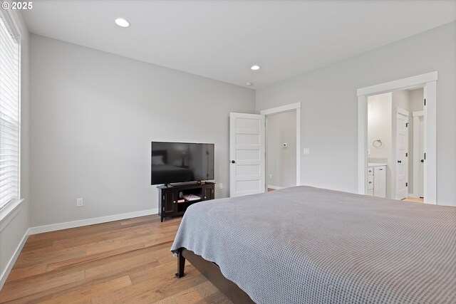bedroom featuring light wood-style floors, recessed lighting, baseboards, and multiple windows
