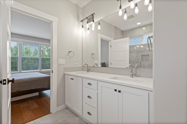 bathroom featuring a sink, a shower stall, and a healthy amount of sunlight
