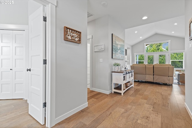corridor featuring recessed lighting, baseboards, high vaulted ceiling, and light wood-style flooring