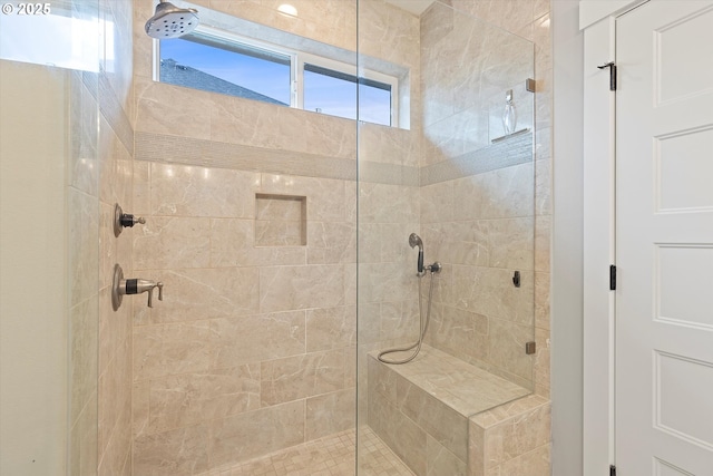 bathroom with tiled shower
