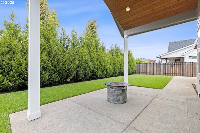 view of patio with a fire pit and fence