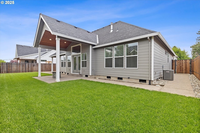 back of property with a lawn, central air condition unit, a fenced backyard, a patio, and a shingled roof