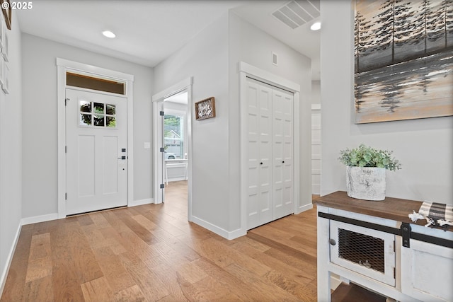 foyer featuring visible vents, recessed lighting, light wood-style floors, and baseboards